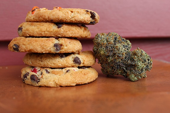 Cannabis dried bud next to a stack of chocolate chip cookies for legalization 2.0